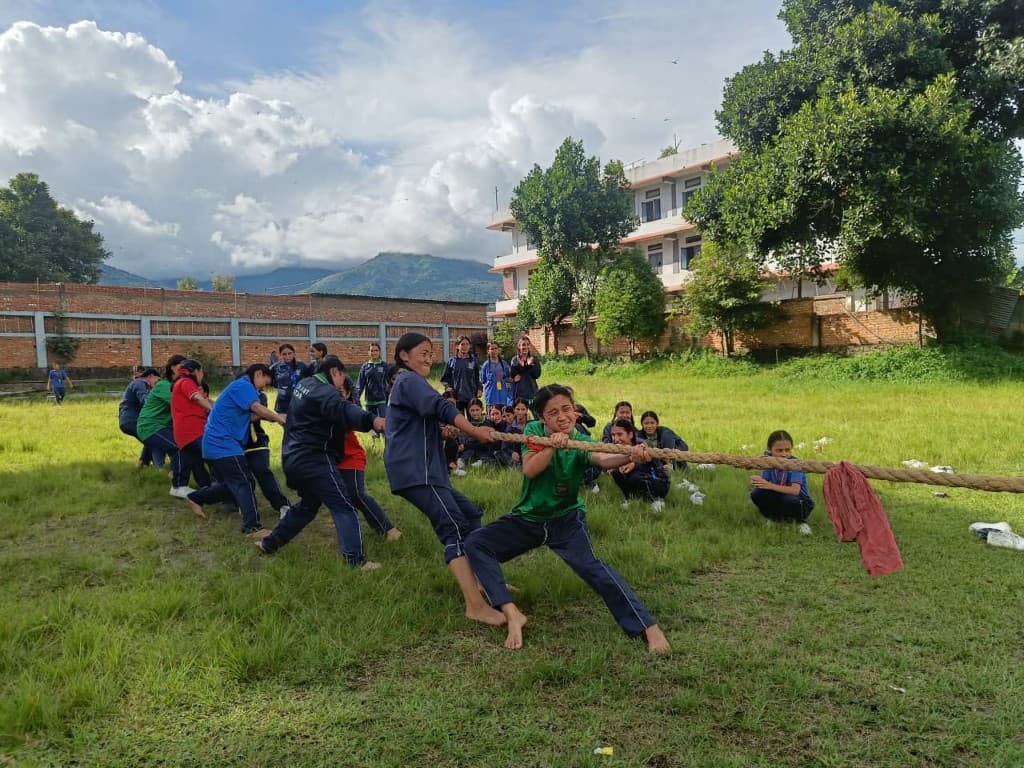 Students competing in tug-of-war on the school field — sports and teamwork at Radiant Star